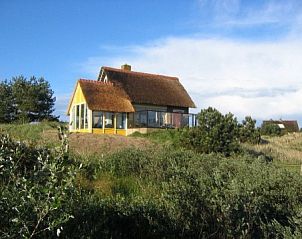 Magnificent view of Markerwaard bungalow in Nes, Ameland, located on a hill with lush surroundings and serene atmosphere on the Wadden Islands.