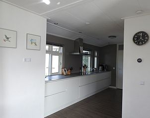 Sleek white kitchen in vacation home Strandloper, Hollum, Ameland.