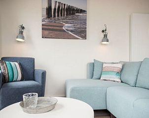 Gezellige zithoek in AMELANDLODGE 4, Hollum, Ameland, met comfortabele banken en kustdecor voor een ontspannen vakantiegevoel.