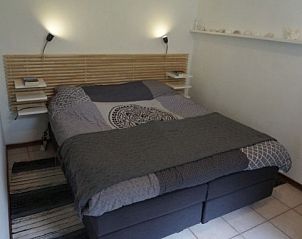 Sfeervolle slaapkamer in DUINVILLA 6, Hollum, Ameland, voor een ontspannen verblijf op de Waddeneilanden.