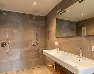 Luxe badkamer in Dorsvloer appartement, Hollum, Ameland. Ruime douche en dubbele wastafel met moderne afwerking.