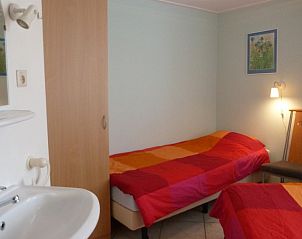 Comfortable bedroom in Fairway bungalow, Hollum, Ameland, with colorful interior on the Wadden Islands.