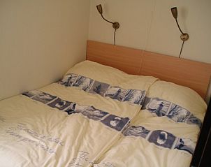 Cozy bedroom in vacation home Kleefkruid, Hollum, Ameland with soft beds.