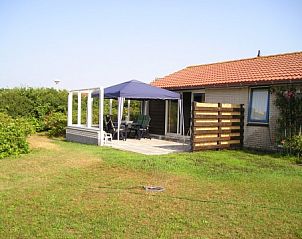 Sunny terrace of Cleavers bungalow, Hollum, Ameland with seating.
