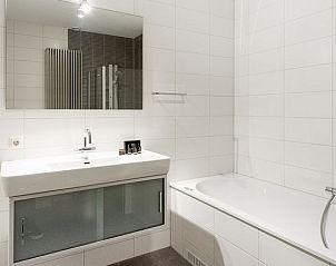 Moderne badkamer met douche en bad in Vitamaris appartement, Schiermonnikoog.