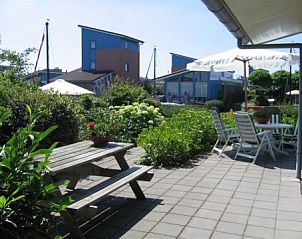Sunny terrace with garden at Recreation Company 'by the water' in Heeg, Frisian lakes.