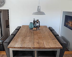 Spacious dining room in Holiday Home in Oudega, located on Lake Heeg in the Frisian Lakes, with a robust wooden table and modern furnishings.