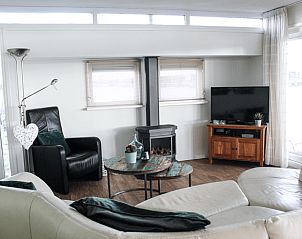 Cozy living room in Holiday Home in Oudega, located on Lake Heeg in the Frisian Lakes, with comfortable seating area and modern furnishings.
