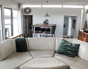 Cozy living room in Holiday Home in Oudega, near Heegermeer, with comfortable seating area and views of the Frisian lakes.