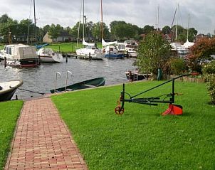 Quiet waters and boats near bungalow in Terherne, Sneekermeer, Frisian lakes.