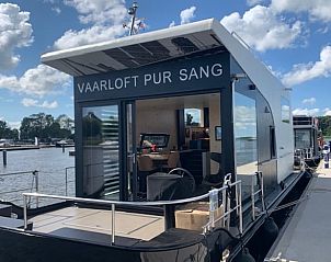 Vakantiehuis in Offingawier met open deuren naar het terras aan het Sneekermeer, Friese meren.