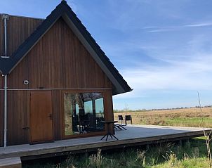 Zijaanzicht van Huisje in Gongahuizen, vakantiehuis in Pikmeer, Friese meren, met ruim terras en uitzicht op velden.