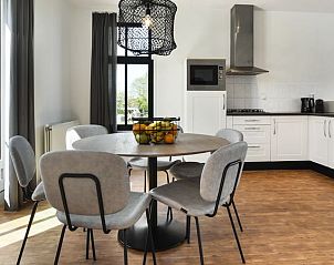 Gezellige eetruimte in Esonstad maisonnette, Anjum, met uitzicht op de groene omgeving.