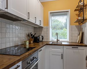 Slaapkamer in vakantiehuis DG1812 in Spier met comfortabel bed en natuurzicht.