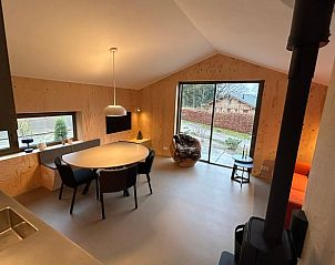 Cozy interior of Holiday Home in Spier, Middle Drenthe with modern furnishings and views of nature through large sliding doors.