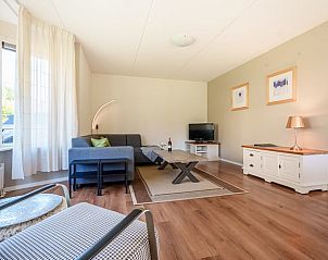 Modern kitchen in holiday home in Schoonloo, Central Drenthe, overlooking a sunny terrace and green garden.