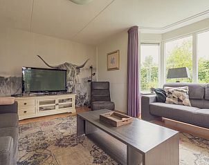 Cozy living room in Holiday Home in Schoonloo, Drenthe with comfortable seating area and natural light, ideal for a relaxing stay.