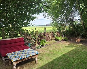 Zithoek in de tuin van Vakantiehuisje in Orvelte, Drenthe met uitzicht op het platteland.