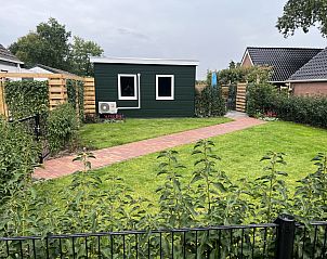 Enjoy the cozy terrace at vacation home DG1936 in De Kiel, Middle Drenthe, surrounded by greenery and tranquility.