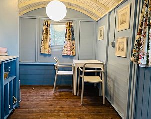 Cozy indoor area of Huisje in Papenvoort, vacation home in Central Drenthe, with wooden interior and cozy sitting area.