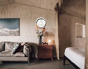 Sfeervolle zithoek en slaapkamer in Vakantiehuis in Odoorn, Midden Drenthe, met moderne decoratie.