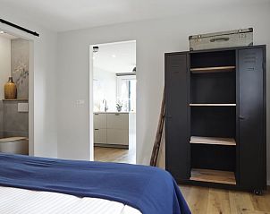 Slaapkamer in Vakantiehuis in Een, Noord Drenthe, met open doorgang naar de keuken en rustieke kast.