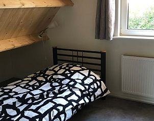 Tweede slaapkamer van Vakantiehuisje in Schipborg, Noord Drenthe, onder houten dakbalken.