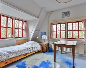 Lichte slaapkamer in Vakantiehuisje in Altena, Noord Drenthe, met uitzicht op bomen.