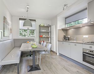 Master bedroom in Aelderholt 6-bed children's bungalow in Aalden, Southeast Drenthe with double bed and warm colors.