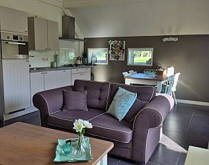 Gezellige woonkamer van Vakantiehuis in Dalerveen, Zuidoost Drenthe, compleet met moderne keuken en eetruimte, ideaal voor een ontspannen verblijf.