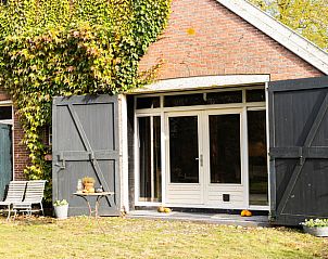 Ingang van Huisje in Valthe, vakantiehuis in Drenthe met charmante bakstenen gevel en houten deuren.