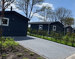 Access road to cottage in Doldersum, Drenthe with modern paving and greenery.