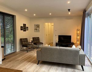 Stijlvolle woonkamer van Vakantiehuis Just Nature in Ruinen, Drenthe, met moderne meubels en veel licht.