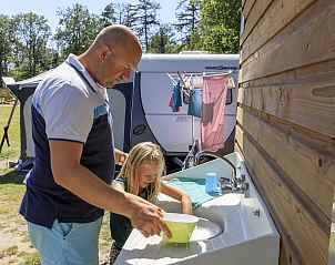 Vader en dochter genieten van het priv sanitair op RCN de Noordster, een rustige kampeerplek in de natuur van Dwingeloo, Drenthe.