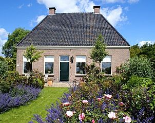 Charmantes Cottage in Ruinerwold, Sdwest-Drenthe, umgeben von blhenden Grten und lndlicher Natur.