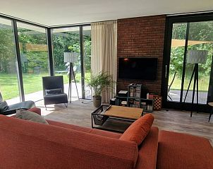 Helles Wohnzimmer mit groen Fenstern in einem Ferienhaus in Wateren, Westerveld.