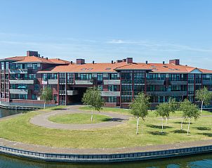 Buitenzijde van Waterparc Veluwemeer 4-persoons appartement 4LA in Biddinghuizen, Flevoland met uitzicht op het water en groene omgeving.