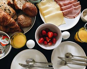 Extensive breakfast with fresh bread and fruit at Holiday Home in Rutten, Eastern Flevoland, for a perfect start to the day.
