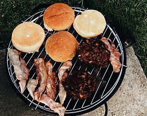 Barbecue with burgers and bacon at Holiday Inn in Rutten, Eastern Flevoland, for a delicious meal.