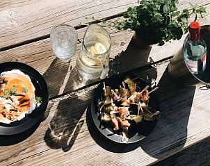Refreshing drinks and snacks on the terrace of Holiday Home in Rutten, Eastern Flevoland, for a summer atmosphere.