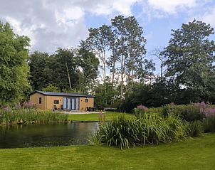 Vacation home FL088 in Kraggenburg, Eastern Flevoland, surrounded by lush nature and a serene pond for a relaxing stay.