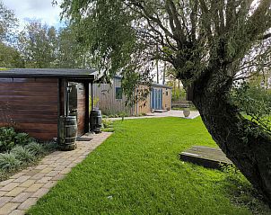 Vacation home FL088 in Kraggenburg, Flevoland with green garden and wooden terrace, ideal for nature lovers.