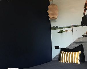 Cozy bedroom in cottage in Kraggenburg with striking wall design in Eastern Flevoland.