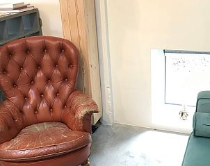 Comfortable reading corner in cottage in Kraggenburg with leather armchair in Flevoland.