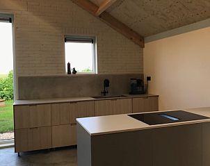 Cozy kitchen in Holiday Home in Kraggenburg overlooking the garden in Eastern Flevoland.