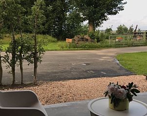 Rustic terrace at cottage in Kraggenburg overlooking green surroundings in Flevoland.