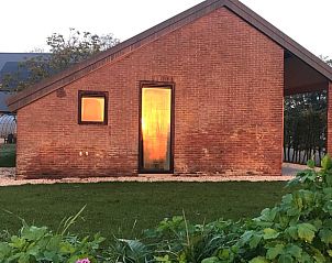 Vacation home in Kraggenburg at sunset, an idyllic spot in Eastern Flevoland.