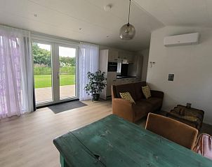 Bright living room overlooking garden in Holiday home in Kraggenburg, Eastern Flevoland, Flevoland.