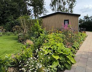 Garden shed in the green garden of Holiday Home in Kraggenburg, Eastern Flevoland, Flevoland.