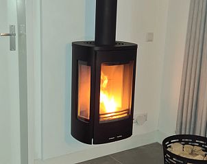 Cozy fireplace in cottage in Zeewolde for warm atmosphere.